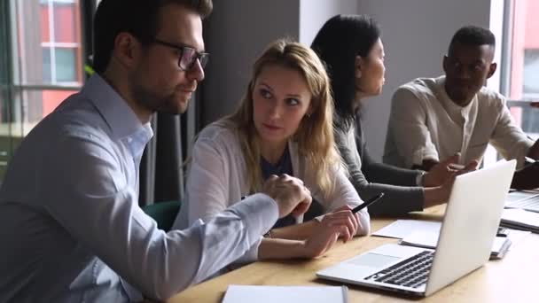 Happy mixed race colleagues working in groups on different projects. — Stok video