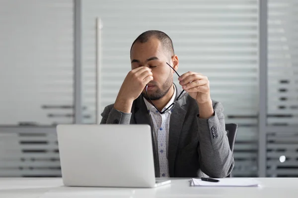 Exhausted male employee massage eyes suffering from headache — Stock Photo, Image