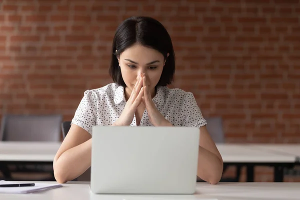 Pensativo empleado femenino mira la pantalla del ordenador portátil pensando —  Fotos de Stock