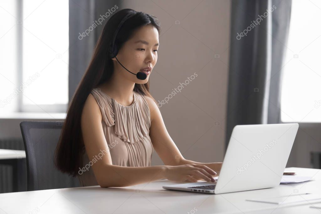 Asian female call center agent consult client online