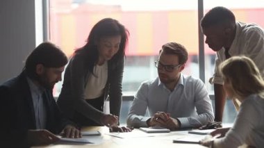 Happy multiracial business people enjoying working together at office.