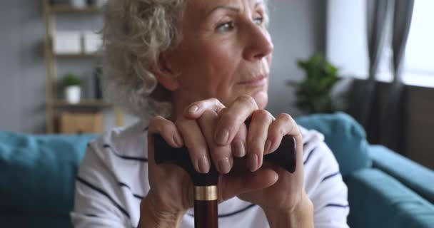 Concentrati sulla donna anziana che si tiene per mano sul bastone da passeggio . — Video Stock