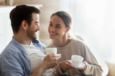 Loving couple enjoy home weekend drinking tea