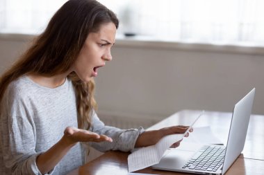 Shocked young woman read band news in letter at home