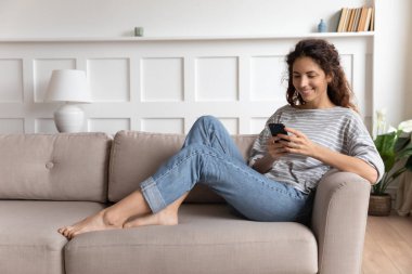 Smiling pretty young woman using funny mobile apps.