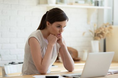 Pensive girl look at laptop screen thinking of problem solution