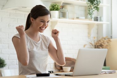 Overjoyed young woman read good news on laptop