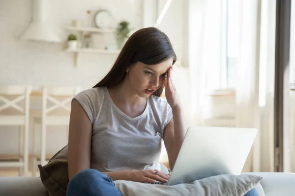 Angstige jonge vrouw met computer operationele problemen — Stockfoto