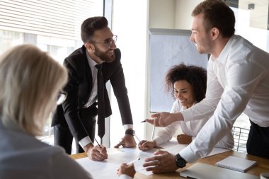 Diverse businesspeople working together on common business project finances
