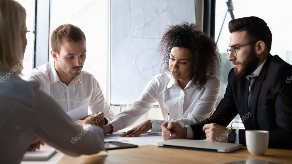 Team participating at group brainstorming lead by african female boss