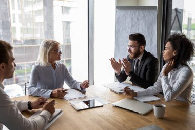 Arabian and aged businesspeople talking during business negotiations in office