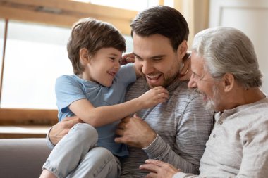 Joyful laughing different generations carefree family having fun indoors.