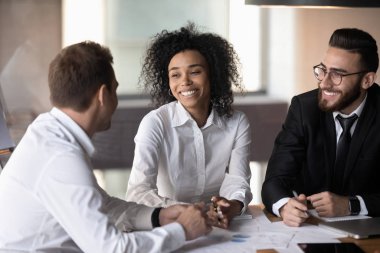 Three diverse professionals working together on new profitable project