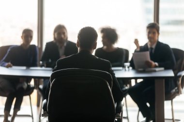 Handsome man applicant back sitting in front HR diverse businessmen.