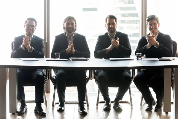 Happy businessmen with applicant resume clap hands for job.