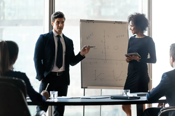 Diverse colleagues flip charts presentation new project in boardroom. — 图库照片