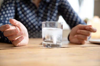 Sick young woman drink dissolving medication feeling unwell
