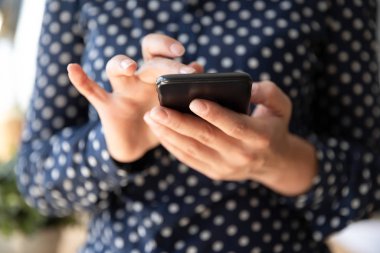 Young woman hold cellphone gadget using wireless internet