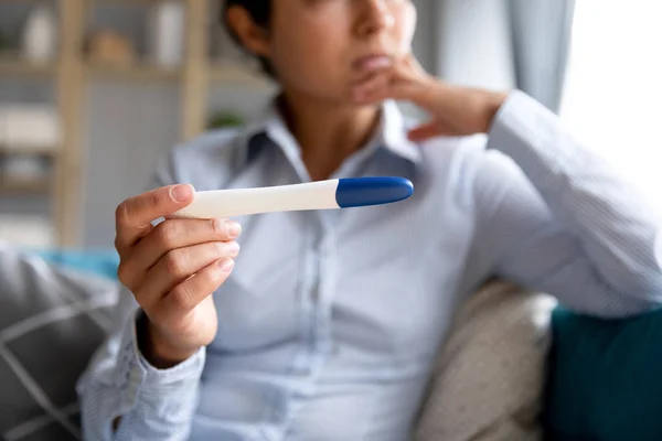 Young woman hold ovulation test waiting for results