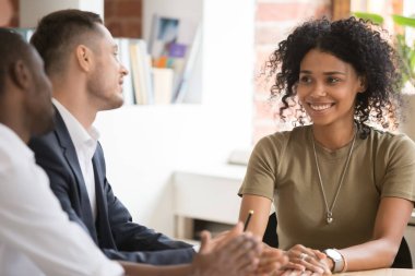 Smiling African American candidate at job interview with hr managers