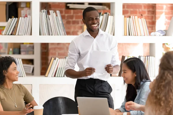 African American businessman with diverse employees having fun at meeting — Stok fotoğraf