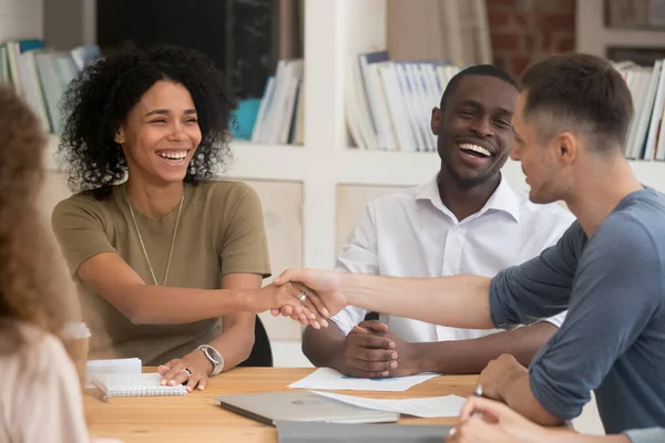 Smiling African American businesswoman handshaking with business partner — ストック写真