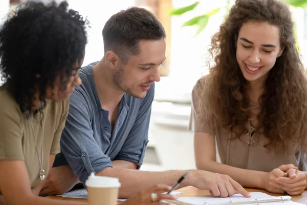 Smiling diverse students or employees working on project together — Zdjęcie stockowe