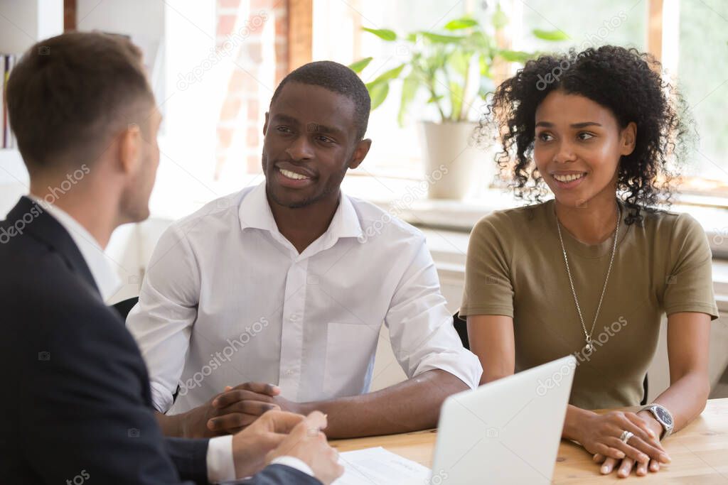 Manager, realtor, insurer consulting smiling African American couple