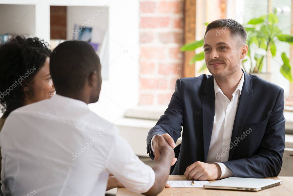 African American couple shaking hand of manager, realtor, making deal