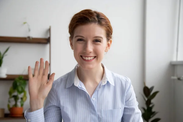 Head shot portrait of attractive smiling businesswoman waving hand — Stock fotografie