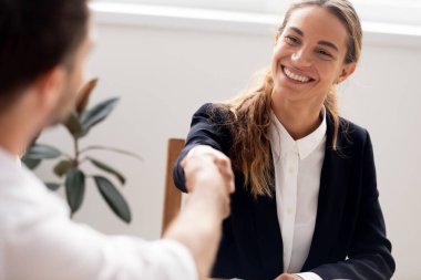 Smiling candidate shaking hand of hr manager, successful interview