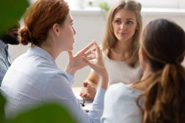 Rear view businesswoman discussing project with diverse colleagues — Stock Photo, Image
