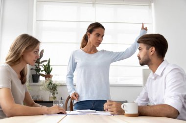 Serious boss scolding employees for bad work results at briefing