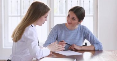 Female patient put written signature on medical form handshake doctor
