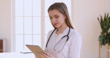 Female professional doctor wear white uniform holding using digital tablet