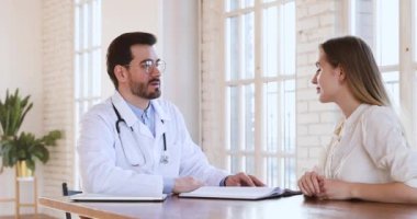 Qualified doctor consult young woman patient at checkup visit