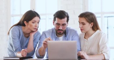 Male mentor explaining web design project data teach female interns