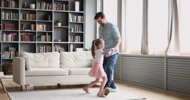 Affectionate dad dancing with child daughter princess in living room — Stok video