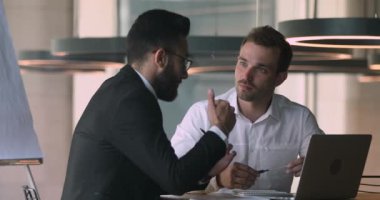 Confident salesman financial advisor explaining deal details to arabic client.