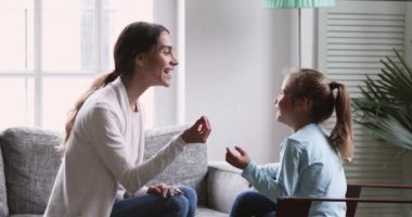 Female speech therapist teaching preschool kid girl learning articulation