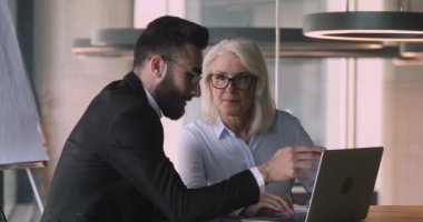 Diverse business people discussing project ideas in office.