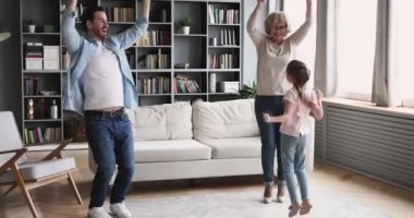 Happy multigenerational family having fun dance together in living room