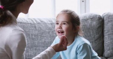 Funny cute kid girl preschooler learning pronunciation with speech therapist