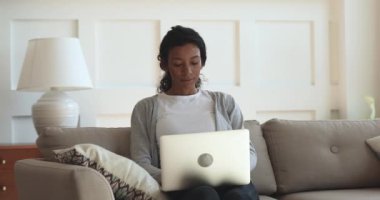 Concentrated african american girl studying on educational online courses.