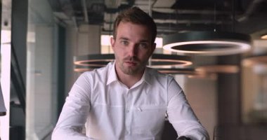 Positive caucasian confident man holding conversation with business client online.