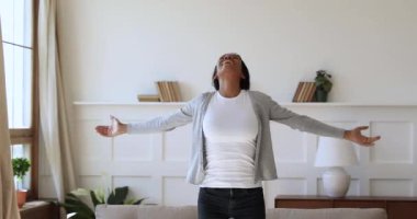 Excited homeowner spinning with stretched arms, real estate concept.
