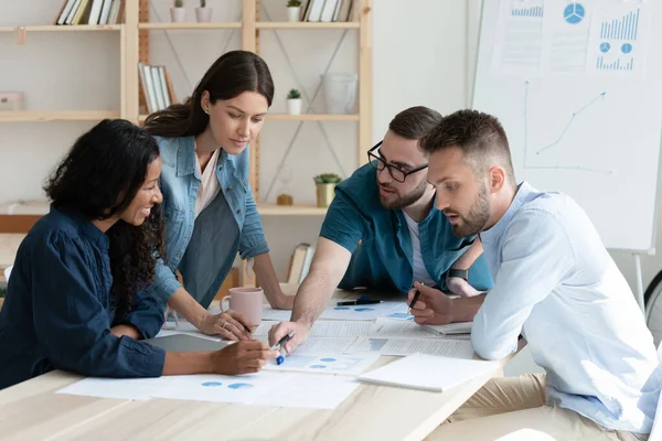 Focused millennial multiracial coworkers discussing accounting reports. — Stock Photo, Image