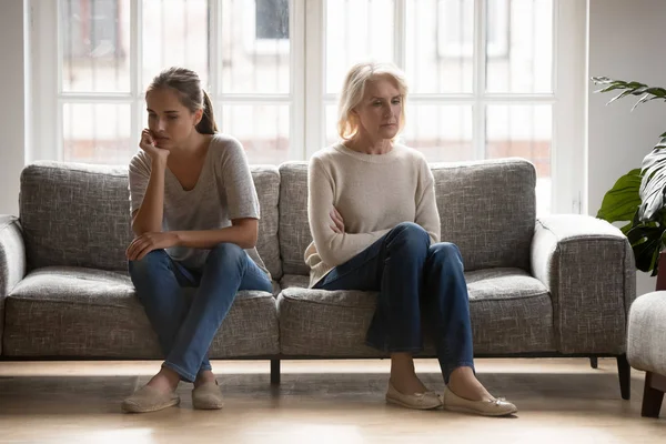 Grown up daughter and retired mother ignoring each other. — Stock Photo, Image