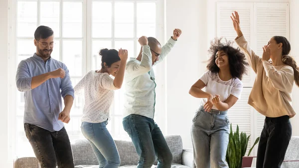 リビングルームで踊る複数の人種の友人が一緒にパーティーを楽しむ — ストック写真