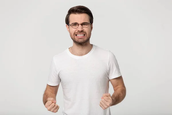 Irritated millennial unhappy guy standing with clenched fists and teeth. — Stok fotoğraf